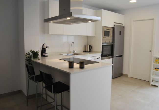 Kitchen area with bar top, and very modern